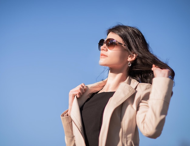 Closeup of confident business woman on a blue background