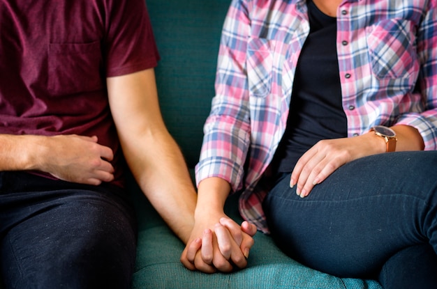 Closeup of couple holding hands