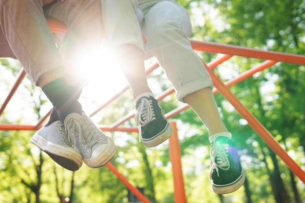 Closeup of couple of teenage feet on a playground in a city park