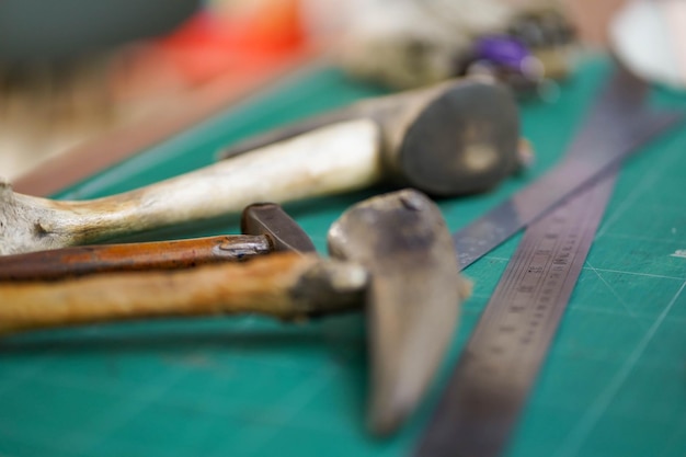 Closeup and crop tools and equipment for leather making with the special hammer made from ox horns