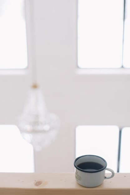 Closeup of cup of coffee in luxury white interior