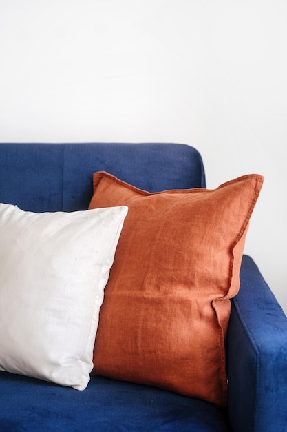 Photo closeup on decorative pillows on comfortable blue couch in living room