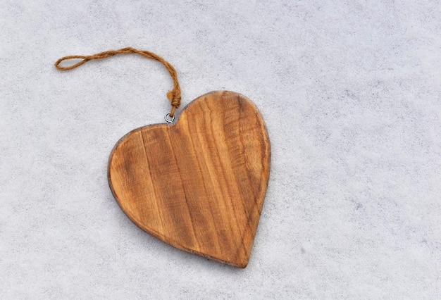 Closeup on decorative wooden shape heart on the snow