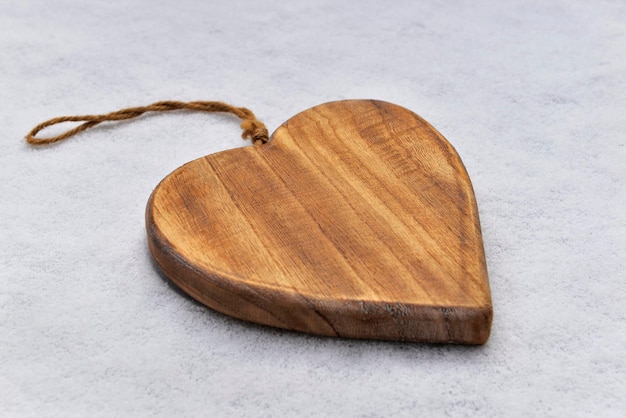 Closeup on decorative wooden shape heart on the snow