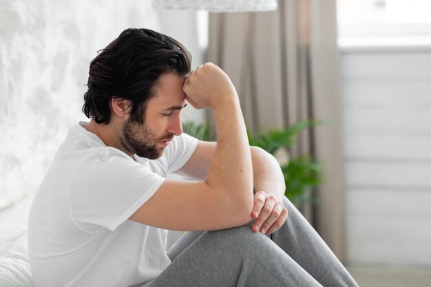 Closeup of depressed millennial guy having bad days