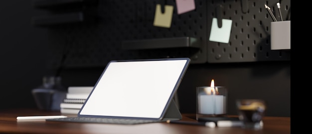 Closeup A digital tablet white screen mockup on the modern dark wood working tabletop