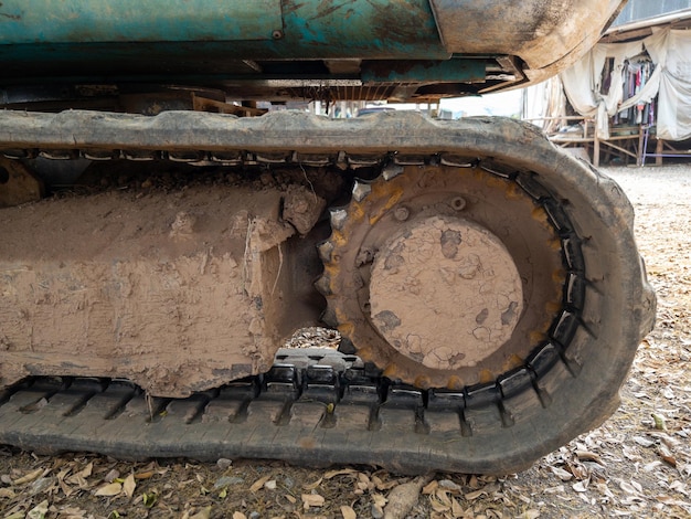 Closeup of the dirty crawler with the dry mud from the paddy field