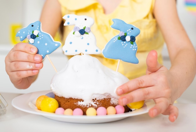 Closeup of an Easter cake decorated with three rabbits and painted eggs Cooking in the kitchen