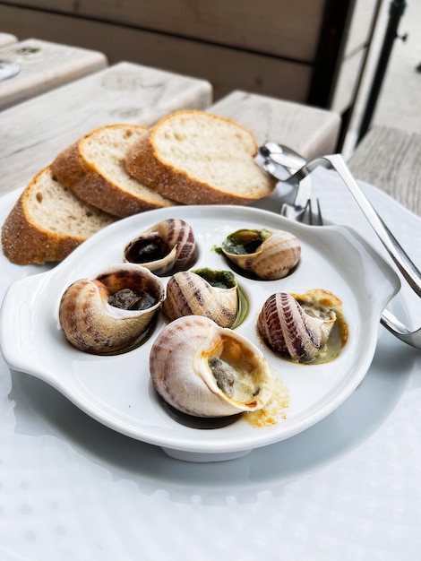 Closeup of eating the fried snails with garlic butter