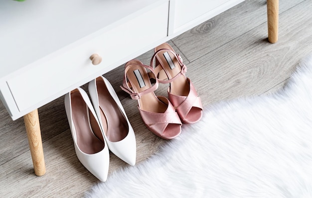 Closeup of elegant high heel shoes standing under feminine dressing table