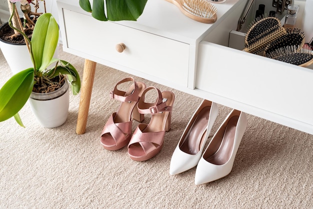 Closeup of elegant high heel shoes standing under feminine dressing table