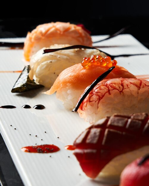 Closeup of elegant piece of sushi salmon on a white plate japan food