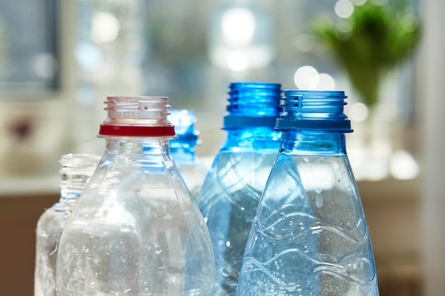 Closeup of empty plastic bottles stand on against the window