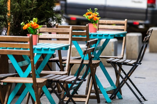 Closeup of empty tables with empty chairs at a local outdoor restaurant in Bucharest, Romania, 2021