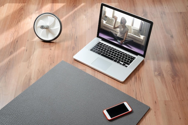 Closeup of equipment for online workout on floor in room