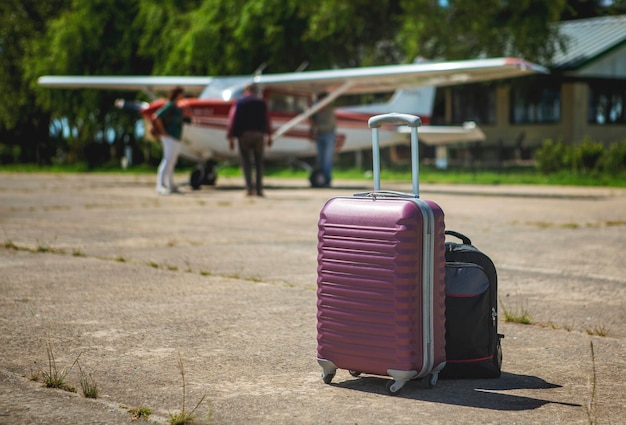 Closeup of equipment on the runway aircraft in the background out of focus passengers