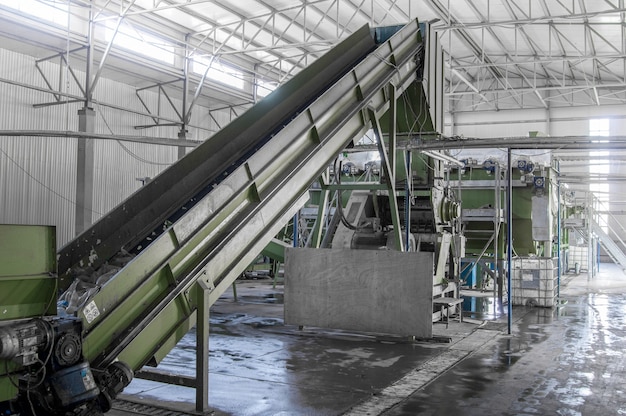 Closeup escalator at the factory for processing and recycling of plastic bottles PET recycling