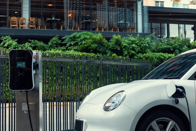 Photo closeup ev car and charger with blur background for progressive concept