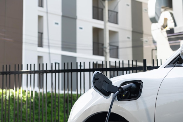 Closeup EV car and charger with blur background for progressive concept