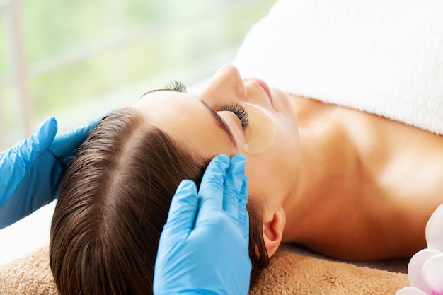 Closeup face woman having facial massage at spa