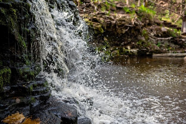 Closeup of falling and splashing streams of water Ivande waterfall Latvia