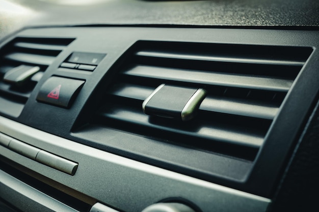 Closeup of the fan or air conditioner grilles in the car interior