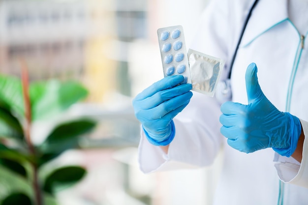 Closeup of female doctor holding pill for men health