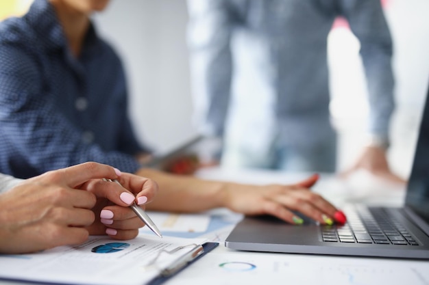 Closeup of female hand with beautiful manicure office worker using laptop for work smart lady