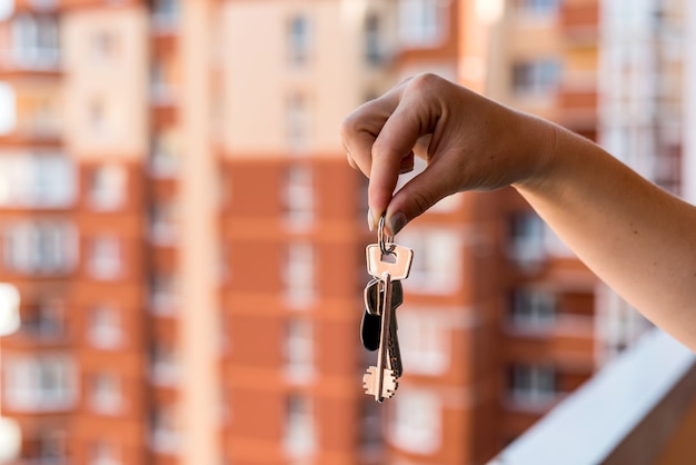 Closeup on female hand with keys from new apartment