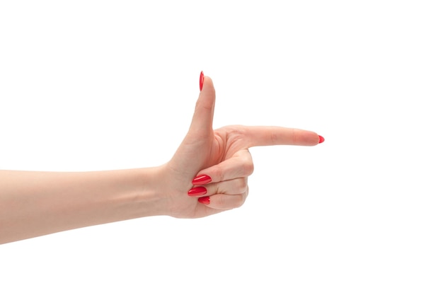 Closeup of female hand with pale skin and red nails pointing or touching