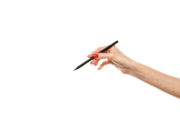 Closeup Female hand writing with a pencil black wooden pencil in hand isolated on white background with clipping path