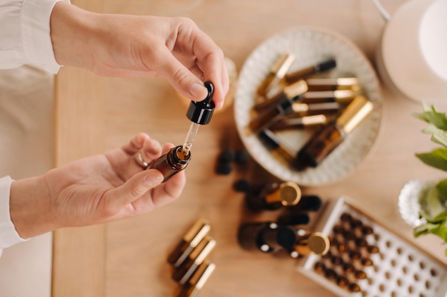 Closeup of female hands holding a bottle of essential oil aromatherapy