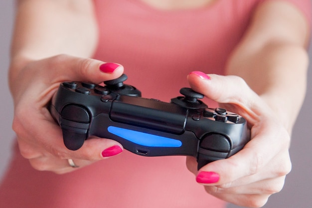 Closeup of female hands with gamepad while playing