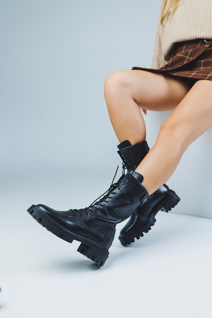 Closeup of female legs in black leather laceup shoes New autumn collection of women's leather shoes 2022