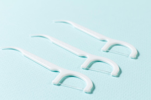 Closeup flossing toothpicks on the blue background