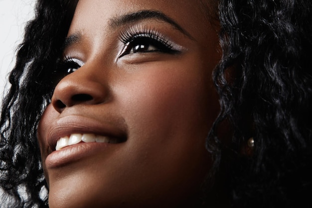 Closeup foto of black woman's face with evening makeup focus on eyes