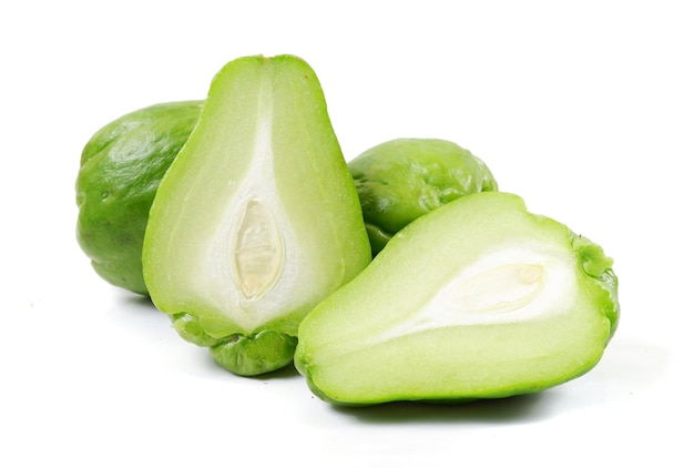 A closeup of fresh green chayote fruits isolated on a white background