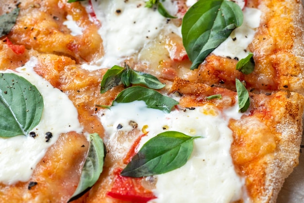 Closeup of fresh hot Roman pizza with herbs and cheese Italian pizza food fast food macrophoto selective focus