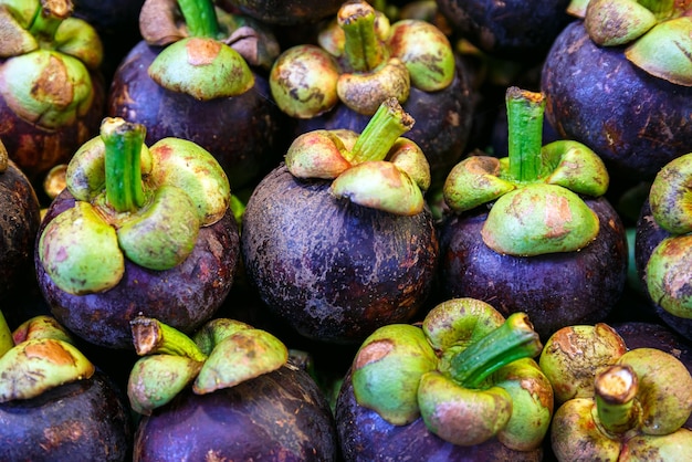 Closeup Fresh ripe mangosteen fruits for sale in a fruit market