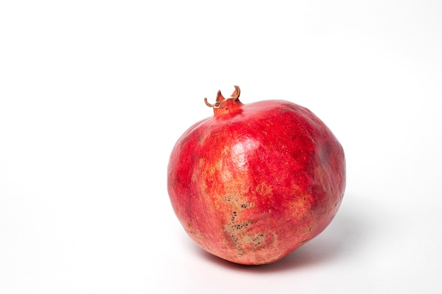 Closeup fresh ripe pomegranate isolated on white