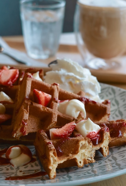 Closeup fresh strawberry waffle with cream