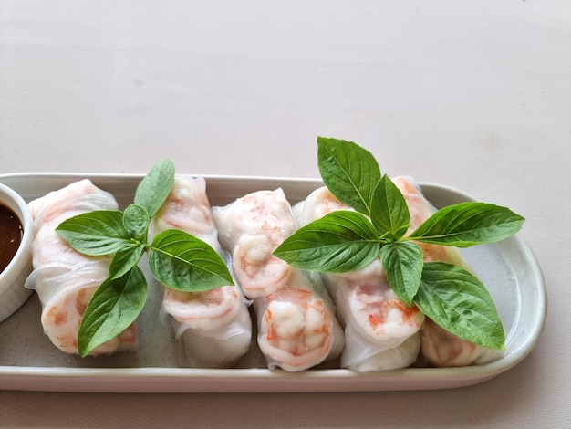 Closeup Fresh Vietnamese Spring Rolls with prawns and top-up basil leaves