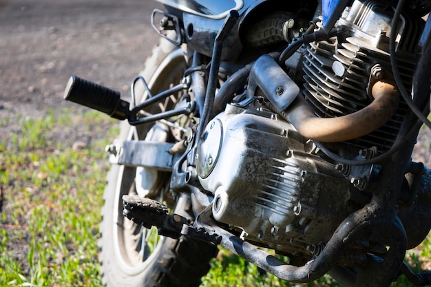 Closeup of the front wheel of the motorcycle parked on the grass