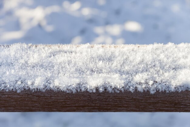 Closeup of frost and snow on the wooden beam