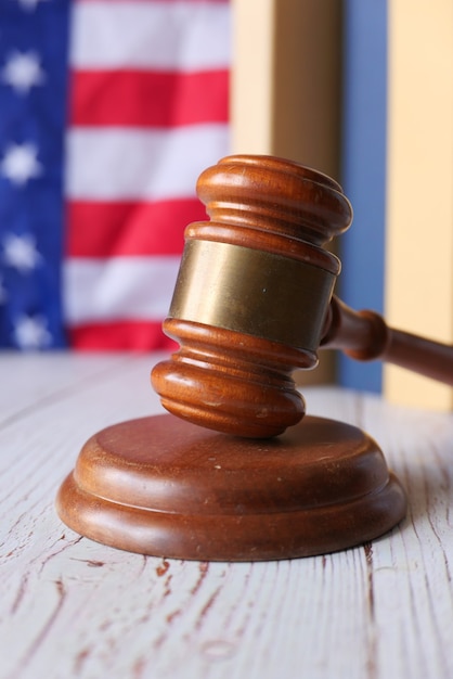 Closeup of gavel and book against american flag