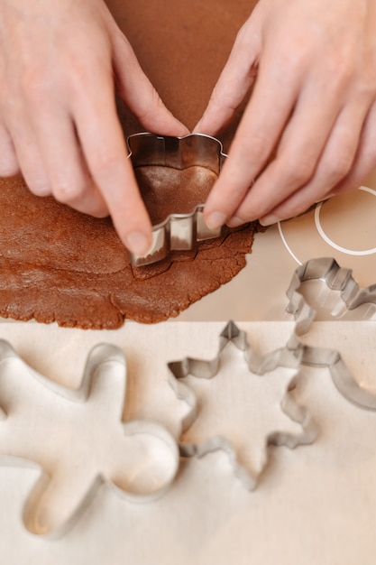 Closeup of gingerbread dough for christmas cookies cut with metal spruce molds