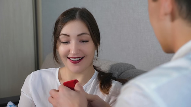 Closeup of a girl accepting proposal and opens ring box for her