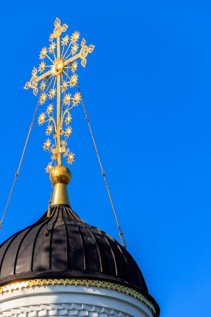 Closeup of golden cross on a dome of orthodox church