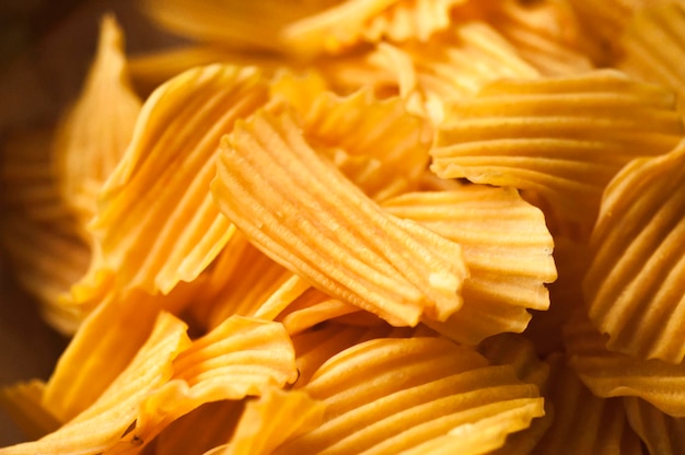 Closeup golden yellow sweet potato chips white background