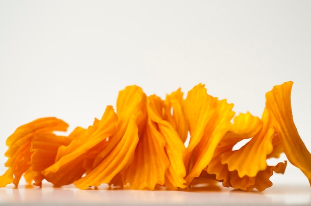 Closeup golden yellow sweet potato chips white background